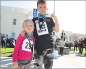  ?? Appeal-democrat ?? Reagan Taylor, 5, and Evan Taylor, 8, cool down following the eighth annual Arbuckle Fun Run 5K on Saturday at Pierce High School.