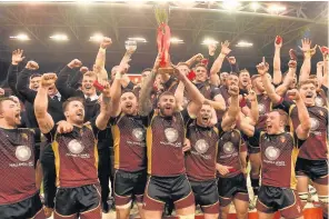  ??  ?? Maredydd Francis of RGC lifts the trophy