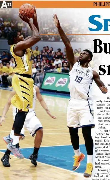  ?? KIMBERLY DELA CRUZ ?? AFTER playing defense all game against UST’s Karim Abdul (left), NU center Alfred Aroga comes up with the biggest shot of the Bulldogs’ season thus far.