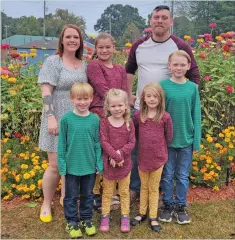  ?? Special to The Saline Courier ?? Cassie Doggett, back row, far left, is pictured with her husband Drew Persinger and their children, front row, from left, Bodhi, Harlyn, Arya, and Wyatt and, back row, Olivia.