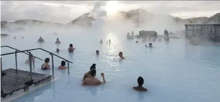  ?? ARNALDUR HALLDORSSO­N/BLOOMBERG FILES ?? Tourists bathe in the Blue Lagoon geothermal spa in Grindavik, Iceland. After years of rapid expansion, troubles are mounting for Iceland’s airlines squeezed by higher oil prices, a problem some say resembles the country’s banking crisis 10 years ago.