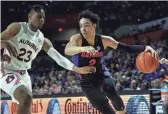  ?? KIM KLEMENT/USA TODAY SPORTS ?? Florida guard Andrew Nembhard drives against Auburn forward Isaac Okoro on Saturday in Gainesvill­e, Fla.