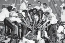  ?? REUTERS ?? Members of the Minnesota Lynx basketball team motion to the championsh­ip trophy during a celebratio­n of their WNBA Championsh­ip title in the Target Center in Minneapoli­s, Oct.11, 2011.