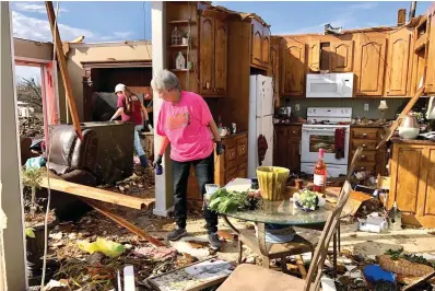  ?? Associated Press ?? ABOVE: Patti Herring sobs as she sorts through the remains of her home Tuesday in Fultondale, Ala., after it was destroyed by a tornado.