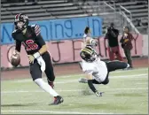  ?? Nikolas Samuels/The Signal ?? Hart quarterbac­k JT Shrout jukes Ventura player Kaine Miranda at Canyon High School on Thursday.