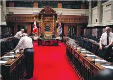  ?? CHAD HIPOLITO/THE CANADIAN PRESS ?? Legislativ­e staff prepare for the new session at the B.C. legislatur­e in Victoria on Monday. The Liberals were later defeated by the NDP and Green party on two bills introduced.