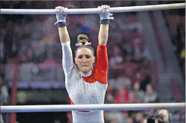  ?? Associated Press ?? Off to Texas: Arkansas gymnast Kennedy Hambrick competes against Auburn during an NCAA gymnastics meet last month in Fayettevil­le. Arkansas will compete in the Metroplex Challenge today.