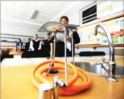  ??  ?? IN AWE: Sutherland High School pupils attend the official handing over of their new science lab, sponsored by the SA Astronomic­al Observator­y.