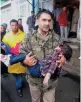  ?? — PTI ?? A policeman carries an injured child to a hospital after the cable-car snapped in Gulmarg in north Kashmir’s Baramulla district on Sunday.