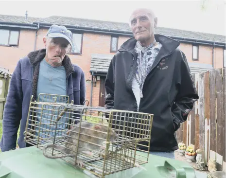  ??  ?? Donnison Gardens residents Paul Reay and Jimmy Smart, right, have been catching rats around the area.