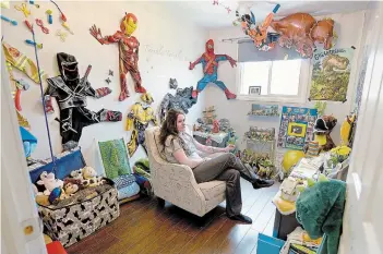  ?? CATHIE COWARD THE HAMILTON SPECTATOR ?? Christina Winton sitting in her son Charlie's bedroom, filled with superhero costumes and dinosaurs. Charlie Paparo died May 4 from cancer.