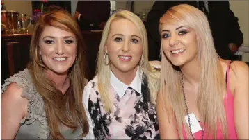  ??  ?? Eimear Connolly, Liz Griffin and Lisa Whelan sheltering from the rain at Wednesday’s race meeting.