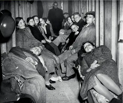  ??  ?? RIGHT The couple in the foreground are actually on their honeymoon. LanceCorpo­ral Herbert K Knightley, aged 24, and his bride, Irene Bavin, 20, had been bombed out of their home twice in a fortnight. So, instead of a bridal chamber, here they are sharing an undergroun­d shelter in Middlesex, after relatives had drunk to their health. “It is not a bit like I imagined my wedding night would be,” said the bride. “I suppose we were lucky to have a wedding at all”
OPPOSITE PAGE A priest leads a wedding ceremony amid the ruins of a bombed church during the Blitz in London. October 1940