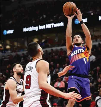  ?? QUINN HARRIS/GETTY IMAGES PHOTOS ?? Suns guard Devin Booker (above) shoots over the Bulls’ Zach LaVine and Nikola Vucevic on his way to 35 points Friday. The Suns’ second-half dominance made positive comments about the Bulls from coach Monty Williams (right) seem generous.