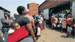  ?? Picture: Jackie Clausen ?? Residents of Glebelands hostel in Umlazi, which has been plagued by violence for years, are given food and hygiene hampers by Gift of the Givers in 2015.