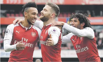  ?? Picture: AFP ?? HAPPY TRIO. Arsenal’s Shkodran Mustafi (centre) celebrates his goal with team-mates Pierre-Emerick Aubameyang and Mohamed Elneny in the match against Watford at the Emirates yesterday.