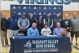  ?? JUSTIN COUCHOT — ENTERPRISE-RECORD ?? Pleasant Valley’s Noah Thomas, front row middle, sits alongside coaches during his signing ceremony with Oregon Tech on Monday at Pleasant Valley High.