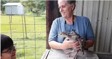  ?? Staff photo by Junius Stone ?? ■ Debbie Binning shows off a turkey chick at Binning Farms. “Turkeys are easy to raise, self sufficient in many ways,” she said. “However, as babies, they have to be taught to eat. Also, they easily get cold, so you need to keep them warm.”