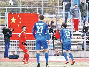  ?? — AFP photo ?? China’s Sun Weizhe (left) vies for the ball Schott Mainz’s Jan Just and Constantin Leinhos during the friendly football match TSV Schott Mainz vs China’s Under-20 team in Mainz, Germany.