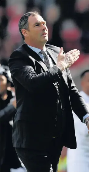  ??  ?? > Paul Clement shows his heart lies in Swansea as he salutes fans following Saturday’s 2-0 win over Sunderland