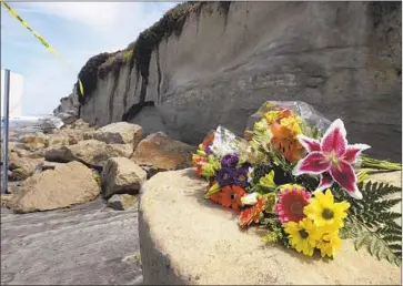  ?? Hayne Palmour IV San Diego Union-Tribune ?? A BOUQUET OF FLOWERS lies on sandstone debris from Friday’s bluff collapse in Encinitas, which killed three people. Coastal cliffs can become unstable as waves chip away at the base or after heavy rainfall.