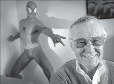  ?? Associated Press photo ?? In this April 16, 2002, file photo, Stan Lee, 79, creator of comic-book franchises such as “Spider-Man,” “The Incredible Hulk” and “X-Men,” smiles during a photo session in his office in Santa Monica, Calif.