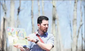  ?? Hearst Connecticu­t Media file photo ?? Audubon Greenwich leader Eli Schaffer reads a page from The Lorax on the trails following the Animal Tale on a Trail program in Greenwich