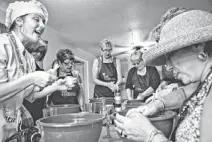  ??  ?? Chef Regina Fostino of Goodyear teaches the group how to make biscotti. The women have also taken wine tours and gone rafting.