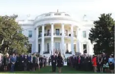  ??  ?? WASHINGTON: President Donald Trump and First Lady Melania Trump stand for a moment of silence to mark the anniversar­y of the Sept 11 terrorist attacks, on the South Lawn of the White House in Washington.—AP