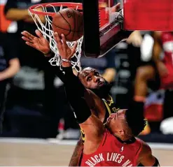  ??  ?? The Rockets' Russell Westbrook, who only had 10 points, goes up for a shot against the Lakers' LeBron James during the first half.