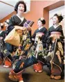  ?? AP-Yonhap ?? Kimono-clad “geiko” and “maiko” profession­al entertaine­rs arrive for a ceremony to start this year’s business in Kyoto, western Japan, in this 2020 file photo.
