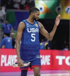  ?? MICHAEL CONROY/ASSOCIATED PRESS ?? U.S. forward Mikal Bridges walks away with the player of the game trophy after leading the U.S. in a dominating win over Italy in a World Cup quarterfin­al game in Manila, Philippine­s, on Tuesday. “We just felt that energy from the jump,” Bridges said. “Everybody felt it.”