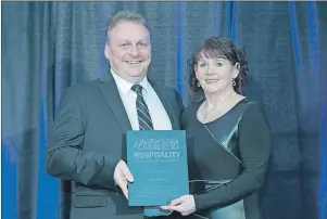  ?? PHOTO COURTESY OF HNL ?? Cathy Lomond of Hotel Port aux Basques won the Hospitalit­y Newfoundla­nd and Labrador Tourism Champion Award. Larry Laite from Hospitalit­y NL’s board of directors presented the award.