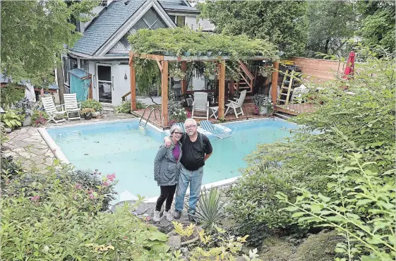  ?? CATHIE COWARD PHOTOS THE HAMILTON SPECTATOR ?? Linda Reynolds and John Bak in their garden, which backs onto the Chedoke Rail Trail. The garden echoes the natural woods behind it but is tamed with pathways, steps and sitting places, carefully chosen shrubs, trees and perennials along with artfully placed stone and rock.