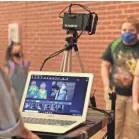  ?? ADAM ROBISON/AP ?? Corinth Elementary School students have their temperatur­e checked by a thermal scanner as they arrive for their first day of school July 27 in Corinth, Miss.