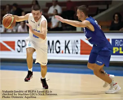  ??  ?? Vukasin Jandric of BUPA Luxol (L) is checked by Starlites GIG's Nick Formosa. Photo: Domenic Aquilina