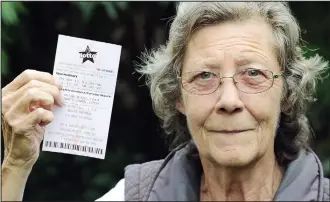  ??  ?? Not so lucky: Elizabeth Wilson with the Lotto ticket she felt left her short-changed