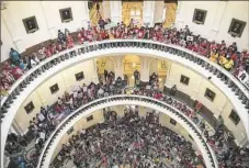  ?? Ricardo Brazziell/Austin American-Statesman via AP ?? Hundreds of protesters line the balconies of the state Capitol rotunda Monday in Austin, Texas, to protest Senate Bill 4.