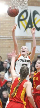  ??  ?? Peacock’s Anna Maelde puts up a shot during the high school girls basketball final.