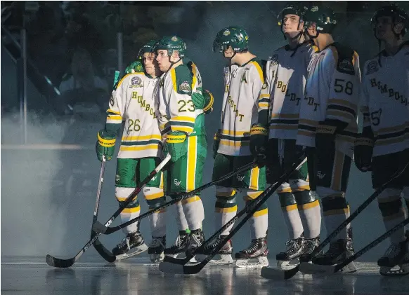  ?? LIAM RICHARDS ?? Humboldt Broncos forward Brayden Camrud, left, and forward Derek Patter hug after introducti­ons before the Broncos’ home opener against the Nipawin Hawks in Humboldt on Wednesday. A sold-out crowd was on hand at Elgar Petersen Arena for the game.