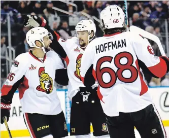  ?? GETTY IMAGES FILE PHOTO ?? Mike Hoffman of the Ottawa Senators celebrates with teammates Clarke MacArthur, left, and Erik Karlsson after scoring a goal against Henrik Lundqvist of the Rangers during the 2017 Stanley Cup playoffs.