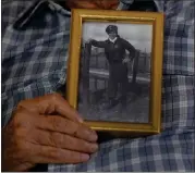  ?? ?? World War II veteran Harold Terens, 100, holds a photo of himself during the war when he was 20 years old.