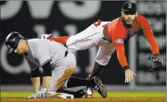  ?? Charles Krupa ?? The Associated Press Red Sox second baseman Ian Kinsler follows through on a throw to first after forcing out Brett Gardner in the seventh inning of Boston’s 5-4 win.