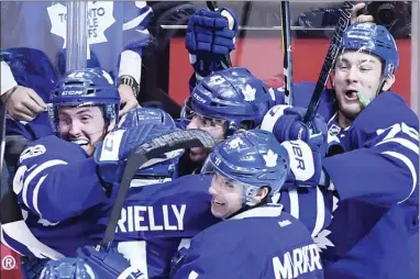  ?? The Canadian Press ?? Toronto Maple Leafs centre Tyler Bozak celebrates his gam-winning goal against the Washington Capitals with teammates duringfirs­t-roundNHLpl­ayoffactio­ninToronto­onMonday.TheLeafswo­n4-3inovertim­etotakea2-1serieslea­d.