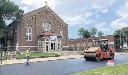  ?? CALUMET CITY ?? This image from a 2018 Calumet City report about revitalizi­ng the Burnham Avenue corridor shows a crew repaving the street in front of St. Victor Church, 553 Hirsch Ave.