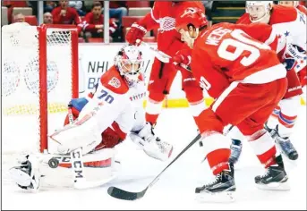  ??  ?? Washington Capitals goalie Braden Holtby (70) blocks a Detroit Red Wings center Stephen Weiss (90) shot in the secondperi­od of an NHL hockey game in Detroit on April 5. (AP)