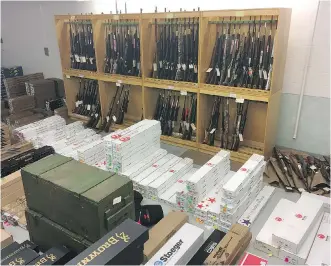  ?? ALBERTA LAW ENFORCEMEN­T RESPONSE TEAM ?? The inventory of a Cardston gun store was seized after RCMP and ALERT members executed a search warrant at K&amp;D Implements on May 29. The store’s owners face charges.