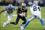  ?? BUTCH DILL - THE ASSOCIATED PRESS ?? New Orleans Saints wide receiver Michael Thomas (13) carries on a pass reception between Carolina Panthers outside linebacker Shaq Green-Thompson (54) and cornerback James Bradberry (24) in the first half of an NFL football game in New Orleans, Sunday,...