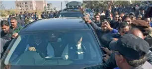  ?? AP ?? A car carrying Nawaz Sharif is surrounded by security guards as he leaves after his court appearance in Islamabad on Wednesday. —