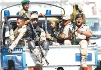  ?? (Khaled Abdullah/Reuters) ?? HOUTHI TROOPS ride on the back of a police patrol truck after participat­ing in a gathering in Sanaa earlier this week.